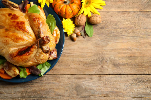 istock Traditional cooked turkey and autumn decor on wooden table, flat lay with space for text. Thanksgiving day celebration 1389846020