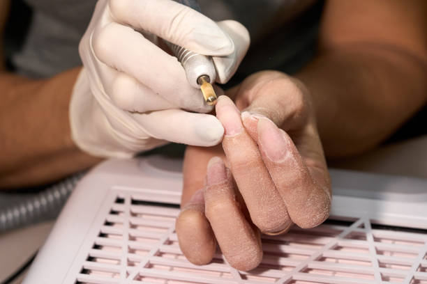istock Woman doing manicure for herself 1389846878