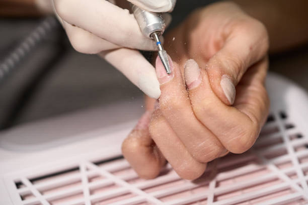 istock Woman doing manicure for herself 1389846886
