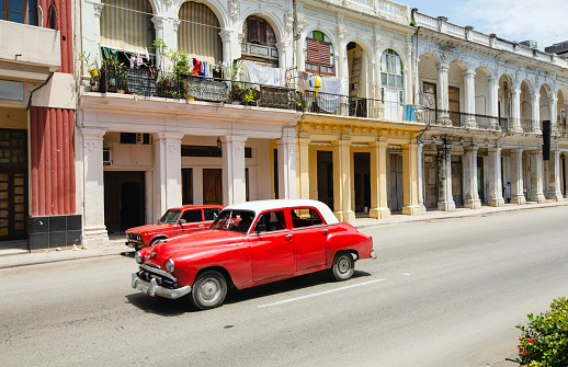 Classic American car taxi in front of old buildings in Havana, Cuba