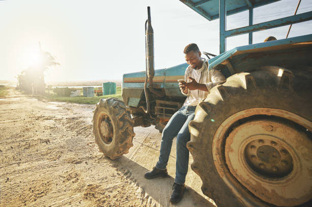 istock Shot of a young man using a cellphone while working on a farm 1389848462