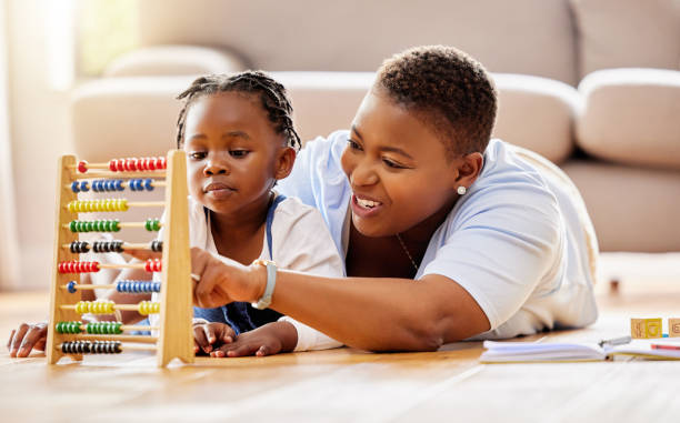 Shot of a mother and daughter using an abacus at home Making learning fun abacus stock pictures, royalty-free photos & images