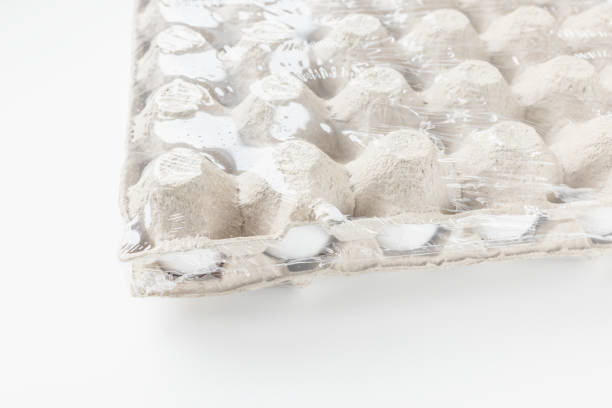 istock Fresh raw 30 pack of large eggs white eggs in cardboard on white background in foil 1389849033
