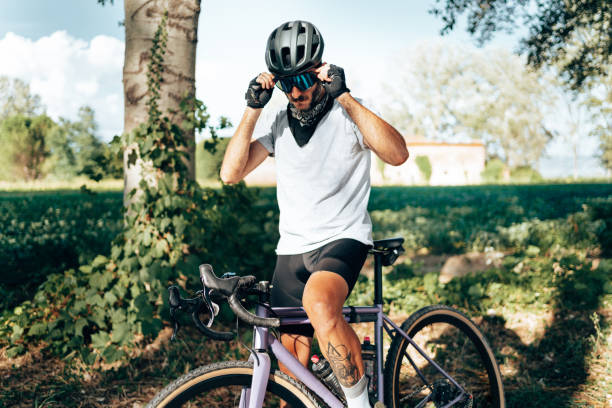 istock cyclist standing in the countryside 1389850162