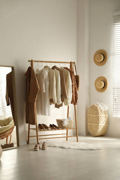 istock Rack with stylish women's clothes in dressing room. Modern interior design 1389850538