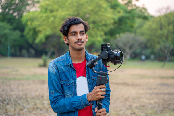istock Young Asian vlogger with the camera. Internet influencer or content creators. 1389851794