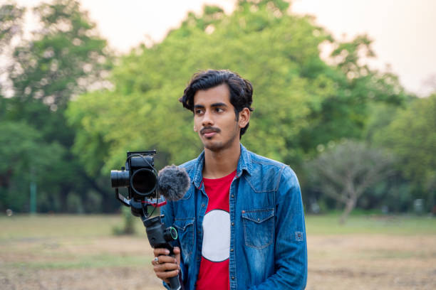 istock Young Asian vlogger with the camera. Internet influencer or content creators. 1389851795