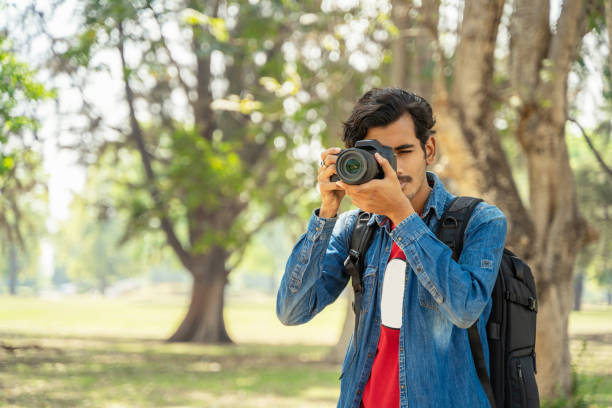 istock Young photographer taking photos with the camera 1389851796