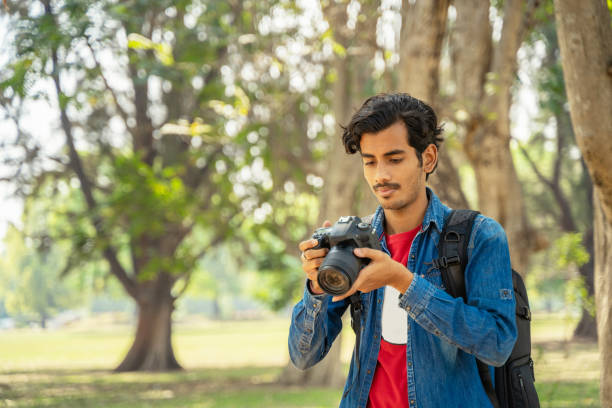 istock Young photographer checking photos in the camera 1389851806