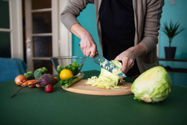 istock Unrecognizable young woman preparing healthy meal 1389855749