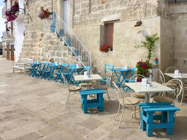 Lovely outdoor seating area with gorgeous view of the sea and fishing boats. Marzamemi, Province Syracuse, Sicily.