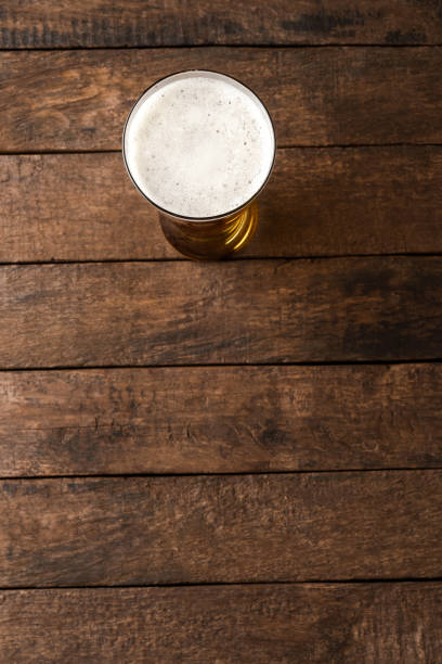 istock Beer glass on wooden table. Close up 1389860761