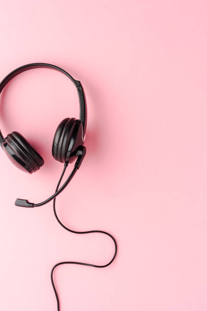 istock Helpdesk headset on pink background. Call center concept. Top view 1389860834