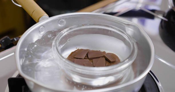 close up melting chocolate in hot boiling water