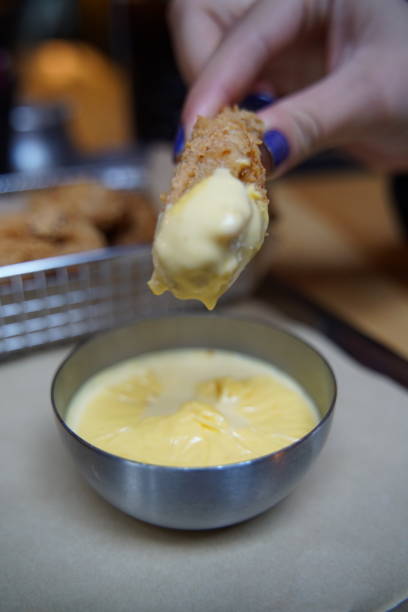 istock Fried chicken piece soaked in cheddar cheese sauce 1389862069