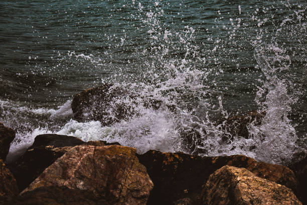 istock Sea wave hitting the rocks on the shore 1389862278