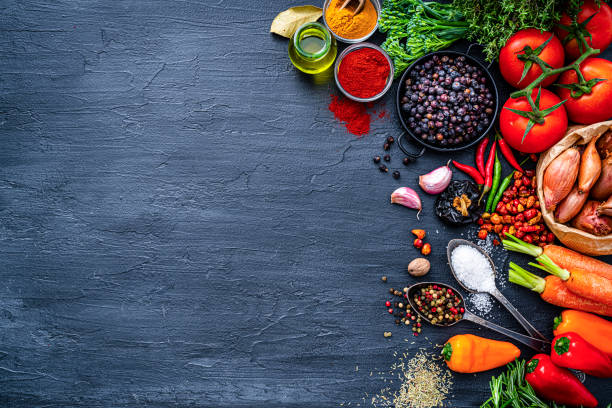 istock Vegetables and spices frame on dark background. Copy space 1389863359