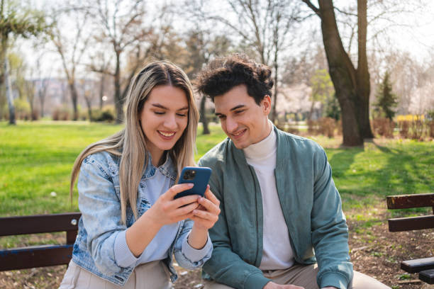 istock Girlfriend showing on mobile phone something to her boyfriend 1389864159