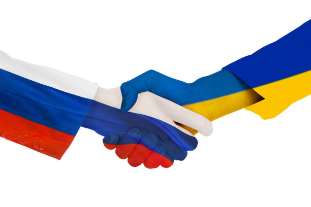 istock Handshake each other with Ukraine and Russia flag 1389866112