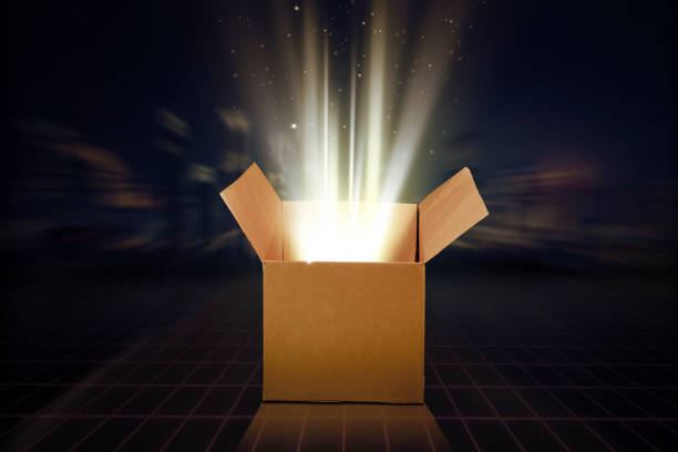 istock Close up of opened cardboard box outs bright glow 1389866118