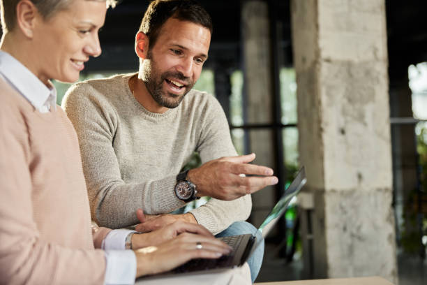 istock Happy entrepreneurs working together on laptop. 1389866646