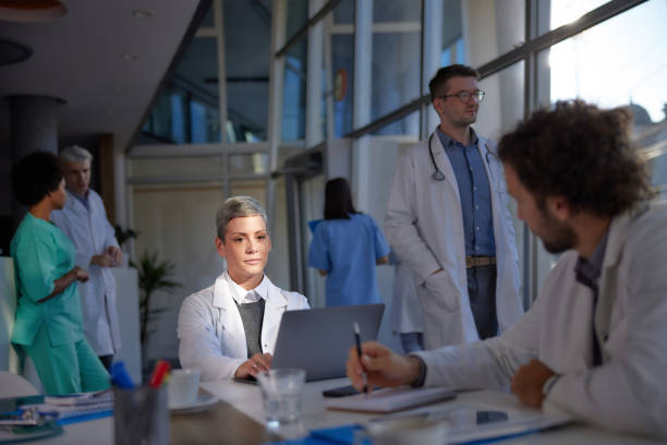 istock Female doctor using laptop while working in hospital. 1389867462