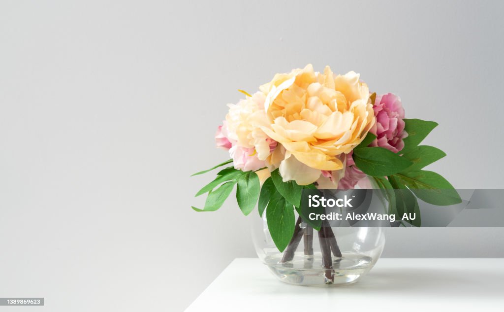 A bouquet of imitation flowers in a glass vase Flower Stock Photo