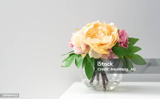 A Bouquet Of Imitation Flowers In A Glass Vase Stock Photo - Download Image Now - Flower, Small, Vase