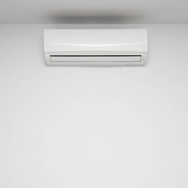 istock White air conditioner hanging on the wall at home 1389869764