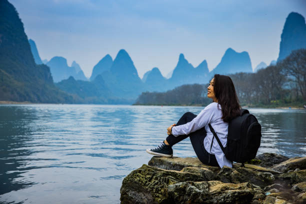 Woman looking at Li River,Guilin,China Woman enjoying view of Li River,Guilin,China guilin hills stock pictures, royalty-free photos & images