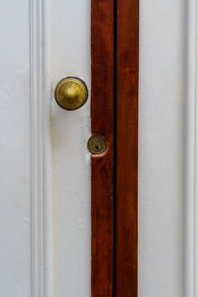 istock Rustic wood door, white and red with lock and handle 1389871961