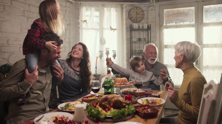 Family dancing and singing during New Year's Eve dinner