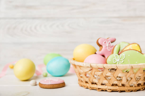 istock Colorful easter cookies in basket with Multi colors Easter eggs on colored background . Pastel color Easter eggs. holiday concept with copy space 1389874455