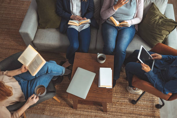 istock Small group of people with a mixed age range having a book club meeting. 1389876231