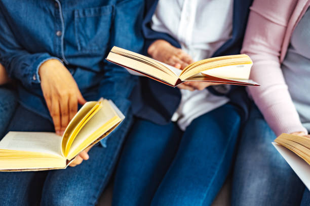 istock Multi-ethnic group of college students reading from a books 1389876743