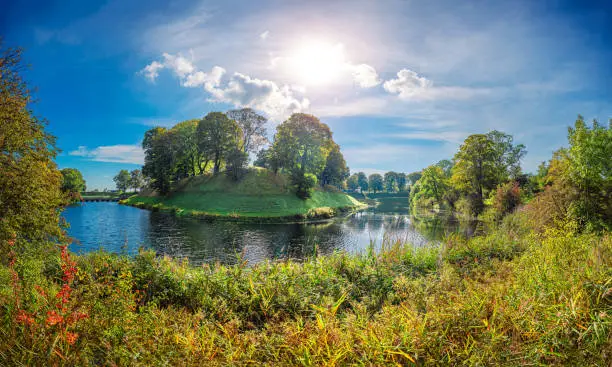 Panorama of the park with water channels and forest around the castle citadel Kastellet, the former earthworks now serving as a greenspace