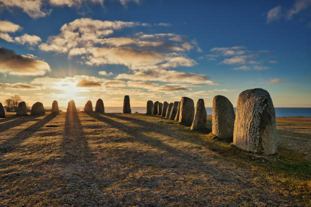 Historical and archaeological site in Sweden Ales Stenar Ales stenar megalithic monument near Ystad in southern Sweden, long shadows in the early dawn ales stenar stock pictures, royalty-free photos & images