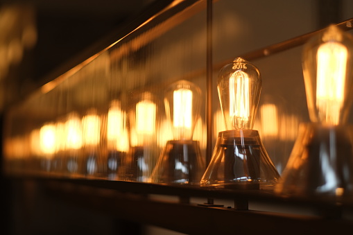 a row of retro light bulbs at night. diminishing perspective