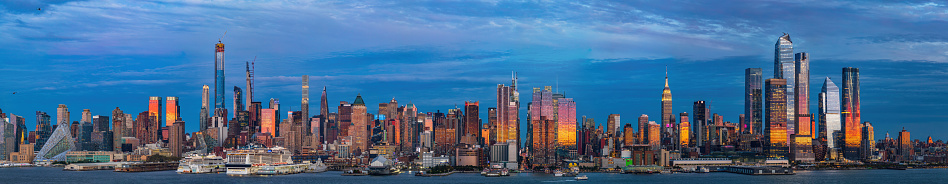 Illuminated Manhattan Skyline after sunset and blue sky, New York, USA.