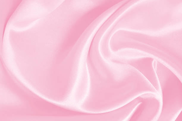 istock Soft pink fabric texture background, detail of silk or linen pattern. 1389880279