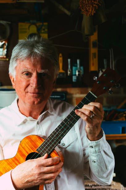 istock Senior man playing ukulele in his garage 1389882821