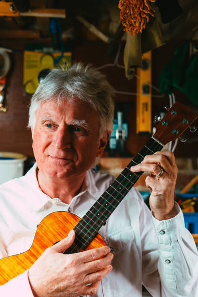 istock Senior man playing ukulele in his garage 1389882822