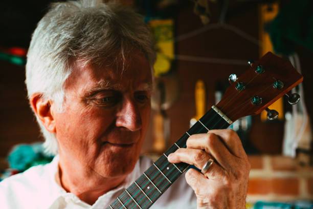 istock Senior man playing ukulele in his garage 1389882837