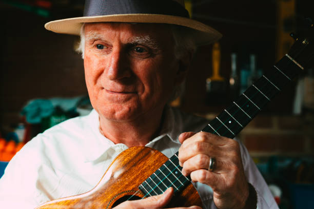 istock Senior man playing ukulele in his garage 1389882863