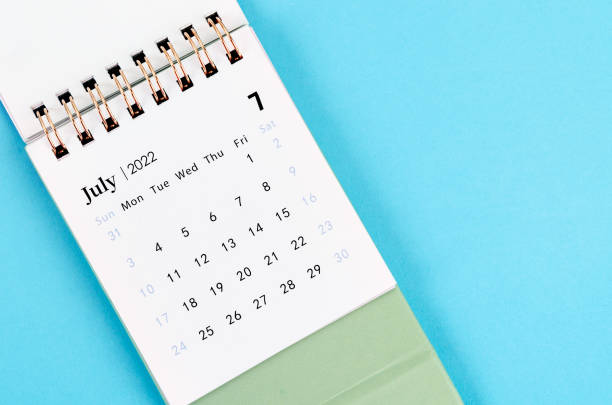 istock July calendar 2022 on blue background. 1389882904