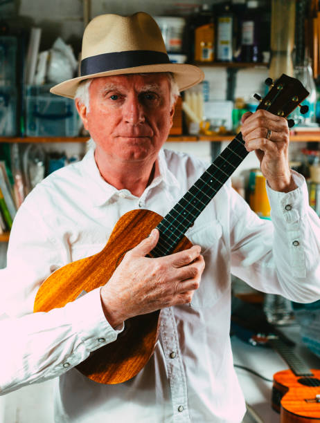 istock Senior man playing ukulele in his garage 1389882909