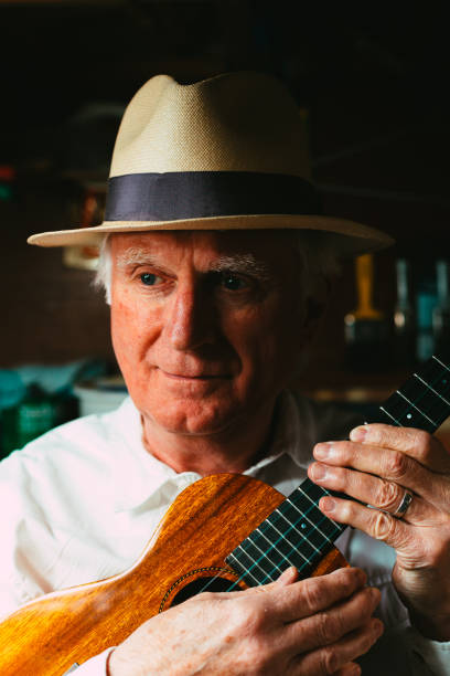 istock Senior man playing ukulele in his garage 1389882911