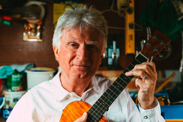 istock Senior man playing ukulele in his garage 1389882920