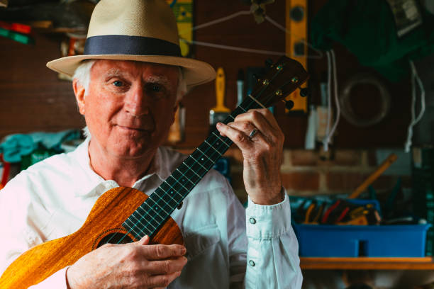istock Senior man playing ukulele in his garage 1389882931