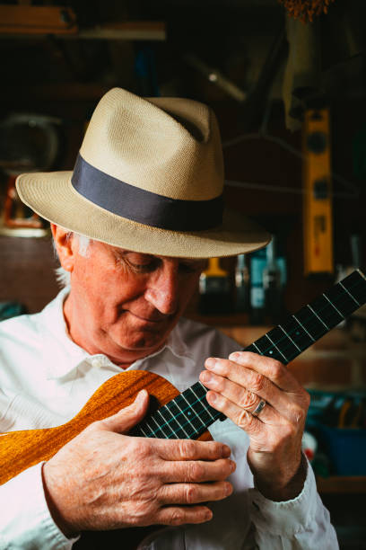 istock Senior man playing ukulele in his garage 1389882935